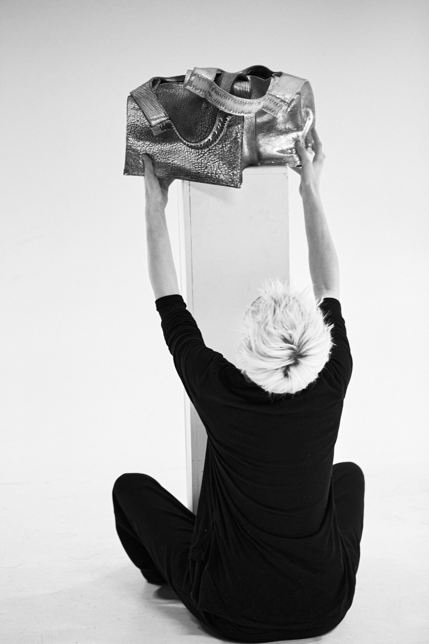 The designer is preparing the bags for the shoot